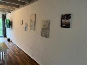 a room with a white wall with paintings on it at Alt Mölln, Apartment 11 in Alt Mölln