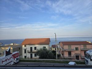 a bus is parked in front of some buildings at Albergo Miva in San Lucido