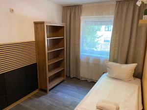 a small room with a bed and a window at Kataleja in Gelnhausen