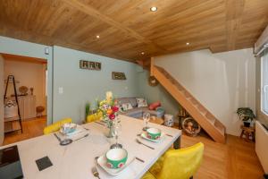 a dining room with a table and yellow chairs at Le Nature - Appartement 4p Wimille -Wimereux in Wimille +25 photos