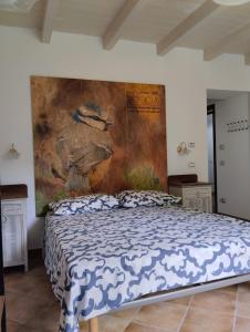 a bed in a room with a painting on the wall at Borgo Doccia 905 in Montese +60 photos