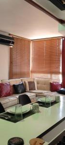 a living room with a couch and a table at Confortable apto tipo Suite/ Turismo Relax in Caracas