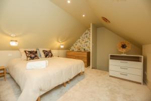 a bedroom with a bed and a dresser in a attic at Le Nature - Appartement 4p Wimille -Wimereux in Wimille