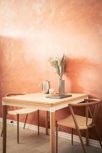 a wooden table with a plant on top of it at Spacious Green Apartment With Amazing Loft in Copenhagen
