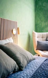 a bedroom with a bed and a chair at Spacious Green Apartment With Amazing Loft in Copenhagen