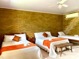 a bedroom with two beds and a ceiling fan at Eco Flat 321 Condomínio Pedra do Rodeadouro in Bonito +22 photos