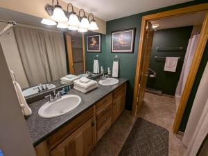 a bathroom with two sinks and a large mirror at Bay View Luxury Studio in Bigfork +8 photos