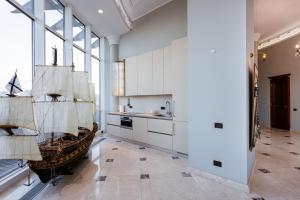 a kitchen with a pirate ship on the wall at Апартаменты RoofPort in Kyiv