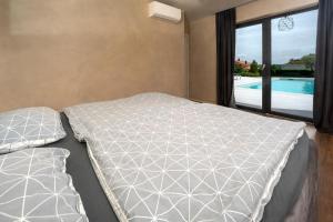 a bedroom with a bed and a view of a pool at Villa Una Sofia in Pazin +63 photos