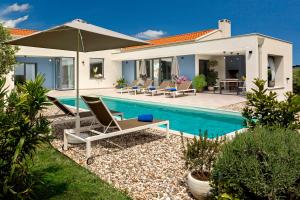 a villa with a swimming pool and a house at Villa Una Sofia in Pazin