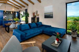 a living room with a blue couch and a table at Villa Una Sofia in Pazin