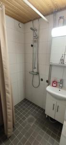 a bathroom with a shower and a sink at Aurora Guest Room in Rovaniemi