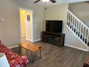a living room with a couch and a flat screen tv at Carter #1 Two bedroom unit near Xavier Downtown in Cincinnati