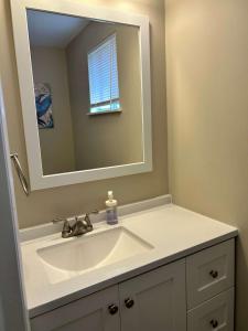 a bathroom with a sink and a mirror at Carter #1 Two bedroom unit near Xavier Downtown in Cincinnati