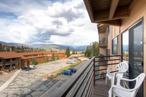a balcony with two chairs and a view of a parking lot at 205-F Buffalo Ridge in Silverthorne