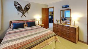 a bedroom with a bed and a dresser and a mirror at 205-F Buffalo Ridge in Silverthorne