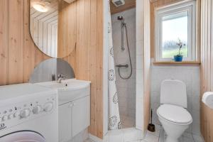 a bathroom with a shower and a toilet and a sink at 4 bedrooms and a beautiful view in Vinderup +25 photos