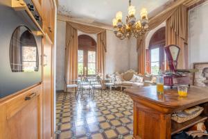 a living room with a chandelier and a table at Villa Petri in Vicopisano +41 photos