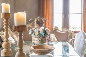 a glass table with two candles and a bowl on it at Villa Petri in Vicopisano