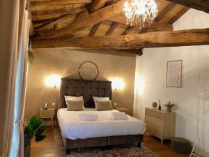 Camiac-et-Saint-DenisChâteau Camiac的一间卧室配有一张带吊灯的大床 更多37张照片
