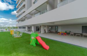 a building with a yard with a slide and a playground at Fortaleza Boggiani in Asunción