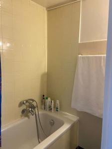 a bathroom with a bath tub and a towel at Studio charmant centré à Lausanne in Lausanne