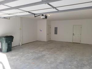 a large room with white walls and a concrete floor at The HoneyBee at Coventry Rows in Omaha