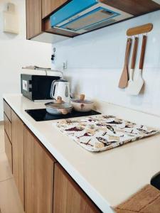 a kitchen with a counter top with a towel on it at Cozy Haven Superior Studio Free Private Parking Netflix in Petaling Jaya