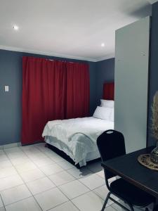 Voodi või voodid majutusasutuse Normans in St Georges strand beach toas