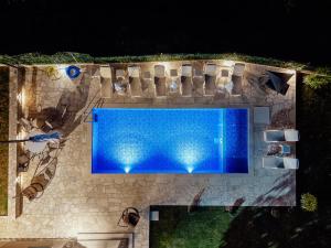an overhead view of a swimming pool at night at Villa Goranovic in Herceg-Novi