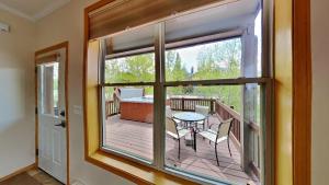 a balcony with a table and chairs and a window at Miners Run 26 in Silverthorne