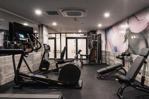 a gym with several tread machines in a room at Wyndham Garden Mazatlan Marina in Mazatlán