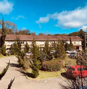 a resort with christmas trees in front of a building at Pousada Quinta do Vale in Gramado