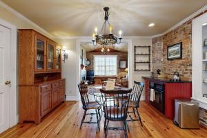 a kitchen with a table and chairs and a brick wall at North Star Manor in Waynesville