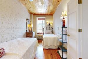 a bedroom with two beds and a wooden ceiling at North Star Manor in Waynesville