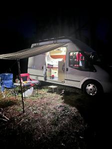 a white van with its door open sitting under a tent at Ford Transit Motorhome-Camper in Batumi +1 photo