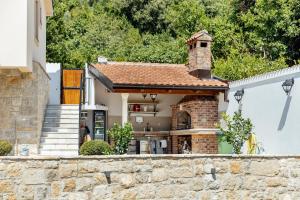 a small brick house with a chimney on top at Villa Goranovic in Herceg-Novi