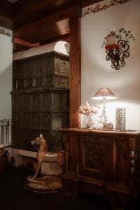 a room with a wooden cabinet and a table with a lamp at Pension Mühlbacherhof in Mühlbach am Hochkönig