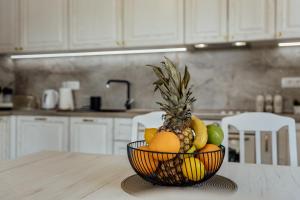 a bowl of fruit on a table in a kitchen at Villa Goranovic in Herceg-Novi