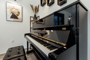 a black piano in a living room at Villa Goranovic in Herceg-Novi