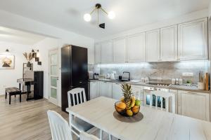 a kitchen with a table with a bowl of fruit on it at Villa Goranovic in Herceg-Novi