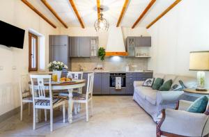 a kitchen and living room with a table and a couch at Tenuta Fiumara in Marina di Grosseto