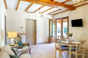 a living room with a table and a tv at Tenuta Fiumara in Marina di Grosseto