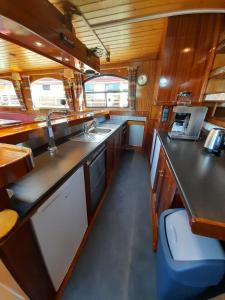 a kitchen with a sink and a counter top at Klipper Stella Frisia in Akkrum