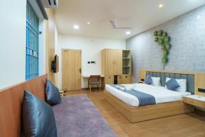 Voodi või voodid majutusasutuse Satyabhama Inn toas