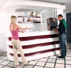 a woman and a man standing in front of a counter at Grand Zeybek Hotel in İzmir