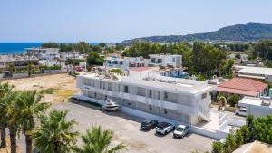 an aerial view of a white building with palm trees at Avi Suites Faliraki in Faliraki