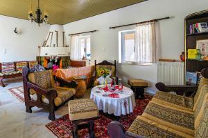 a living room filled with furniture and a table at Grandma's House Mani in Plátanos