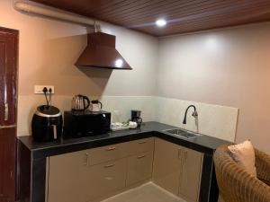 a kitchen with a sink and a counter top at Donna's Homestay in Ghum