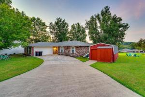 a house with a red garage and a driveway at Beaver Lake Retreat with Deck Paddle, Bike, Relax! in Springdale